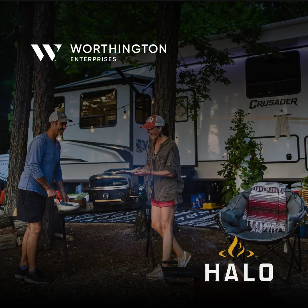 A couple enjoying a pizza from the HALO versa 16 pizza oven