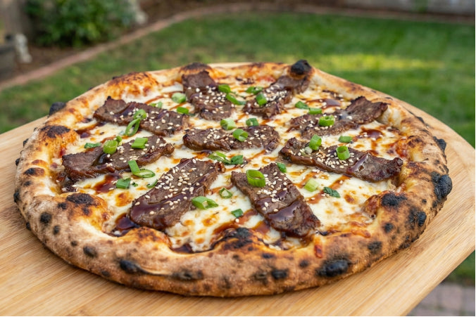 Beef Bulgogi Pizza with melted cheese, toasted sesame seeds, and freshly sliced green onions