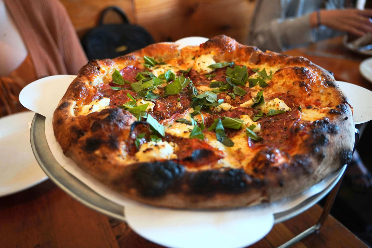 A pizza with burnt edges and raw middle