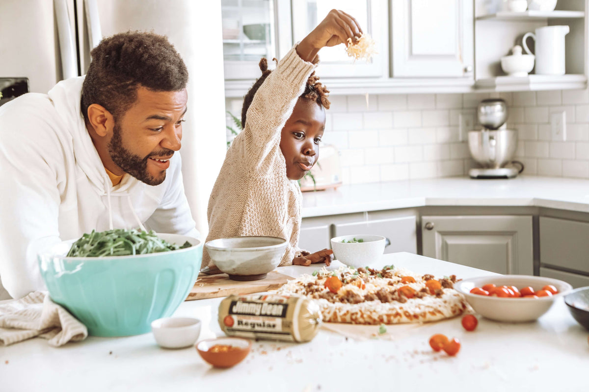 a family cooking pizza together