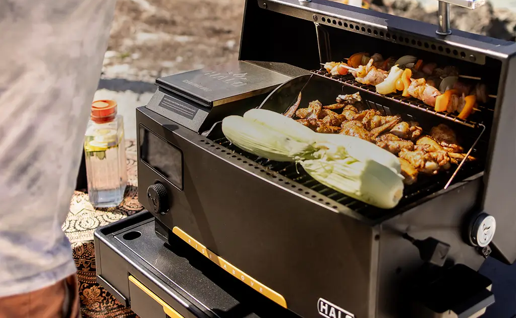 a man is cooking outdoors using a pellet grill