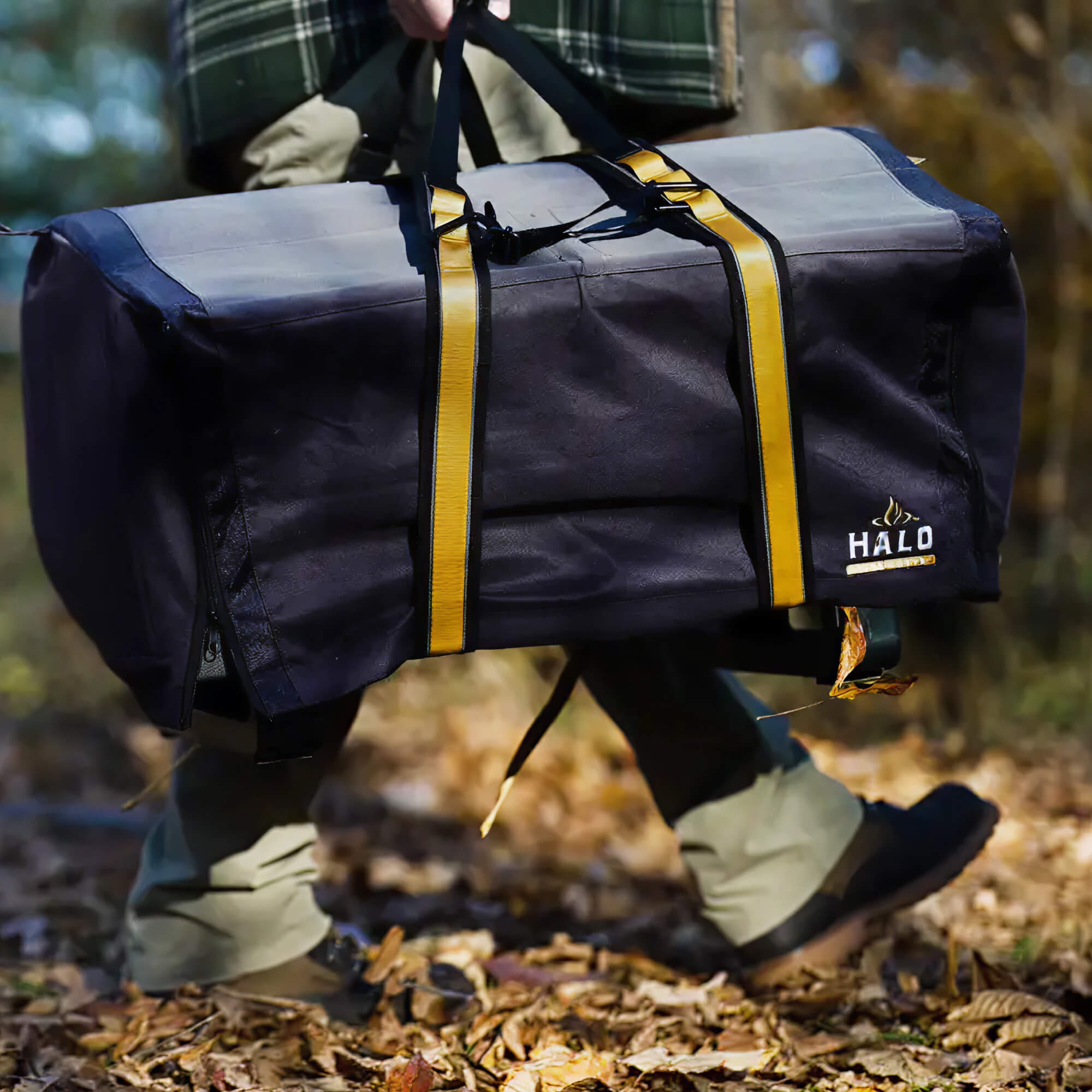 Person walking outside while carrying a HALO Elite1B griddle with heavy-duty straps.