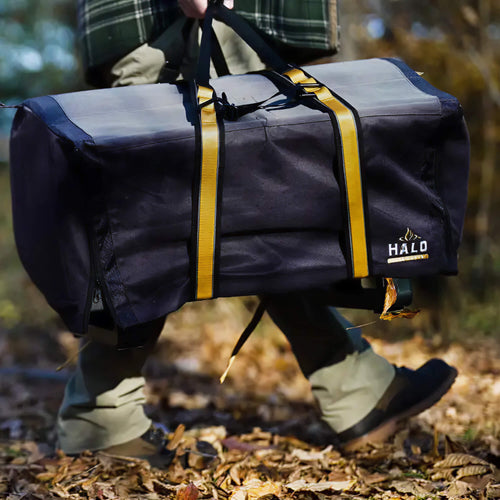Person walking outside while carrying a HALO Elite1B griddle with heavy-duty straps.