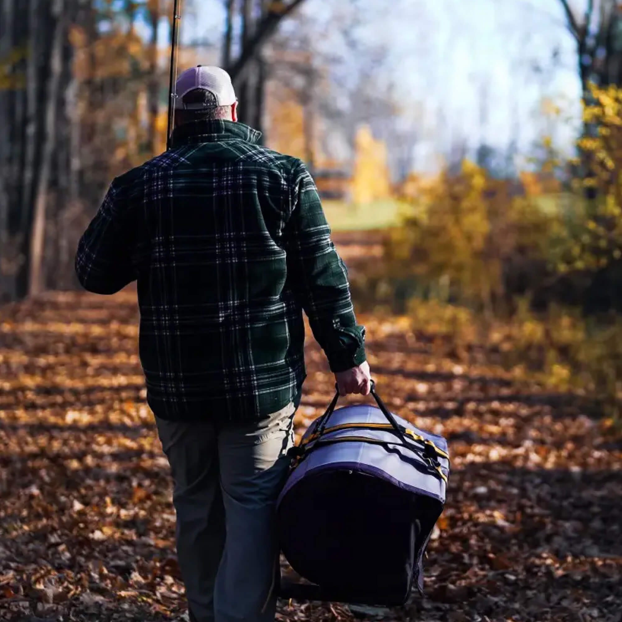 Transporting a HALO pellet grill effortlessly with carrying straps for a backyard cookout.