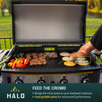 Outdoor cooking on a HALO Elite 4B griddle featuring a large inset plate for wind-proof performance.