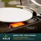 Close-up of a Halo pizza oven open, featuring the infrared bottom burner and rotating stone