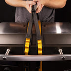 Person using HALO countertop appliance carrying straps to lift a griddle.