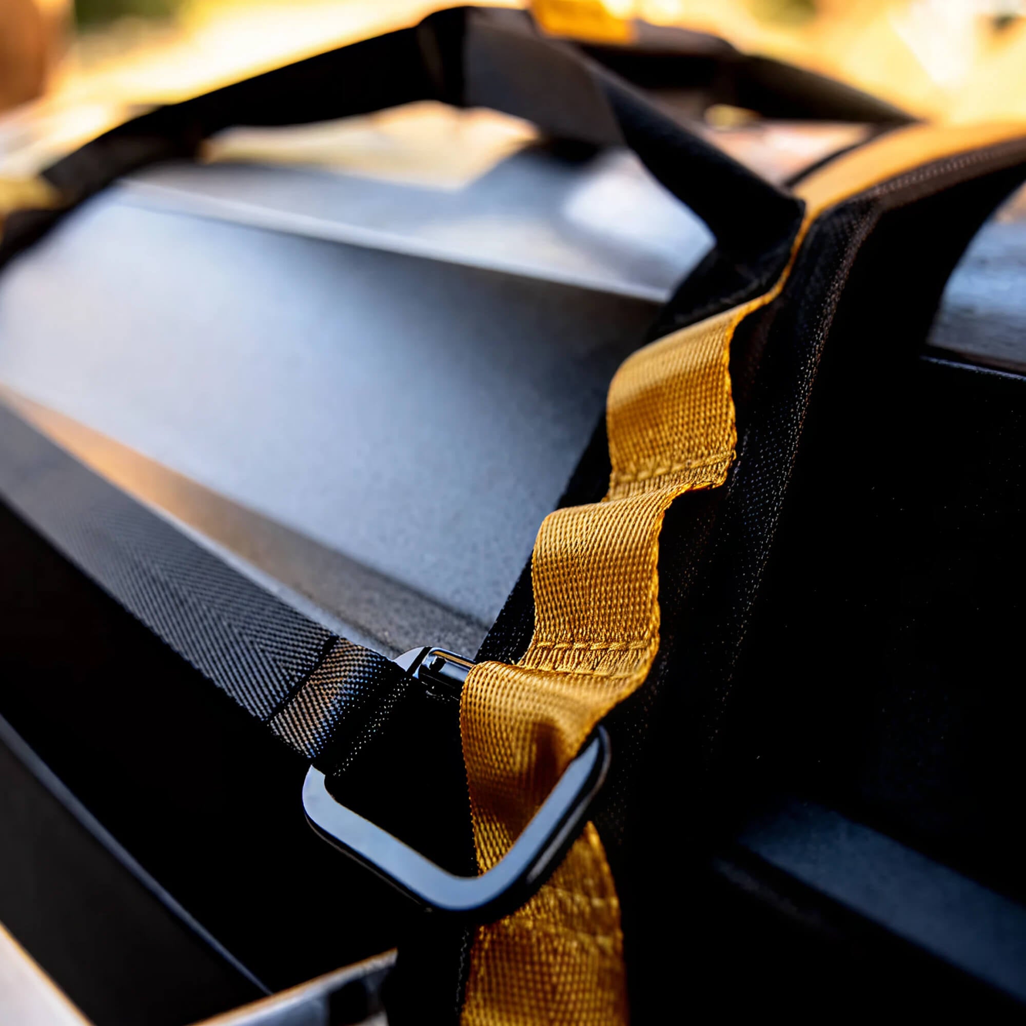Close-up of the durable yellow heavy-duty strap on a HALO grill cover.